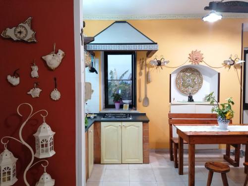 a kitchen and dining room with a table and a counter at La pomelia in Casa Di Natale