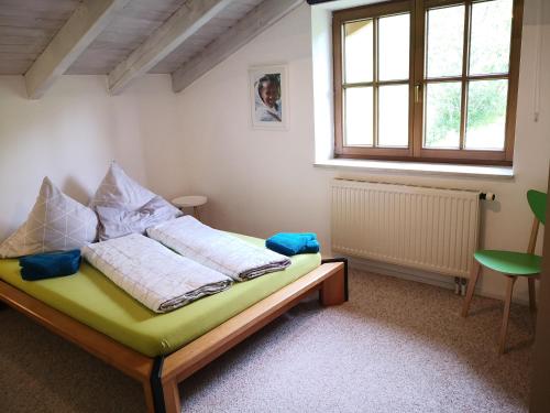 a bedroom with a bed in a room with a window at Jungholz Erlebnis in Jungholz