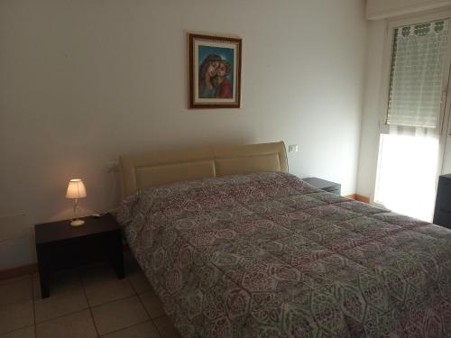 a bedroom with a bed and a picture on the wall at villa a mare in Senigallia