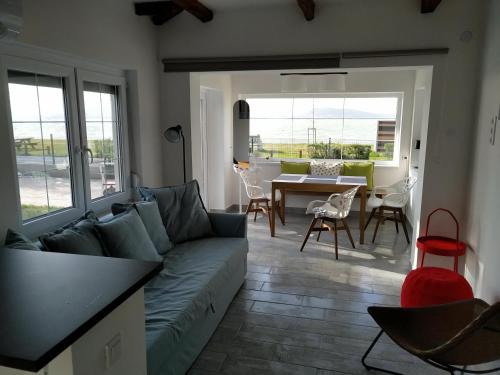 a living room with a couch and a table at Exclusive Beachfront Villa in Fonyód