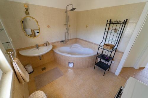 a bathroom with a tub and a sink and a mirror at Villa Jugo (6+2) - New - Mediterranean ambient in Gornje Selo