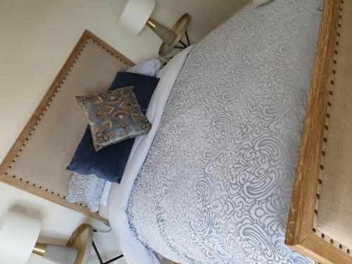 an overhead view of a bed with blue pillows at Cong Getaway Lodge in Mayo