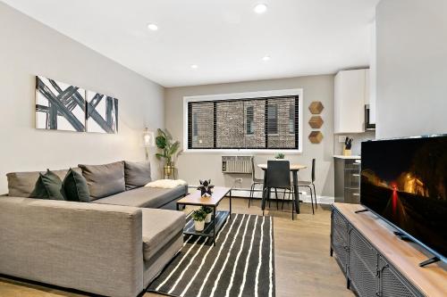 a living room with a couch and a tv at Best Studio Apt in Chicago close to Boystown - Oakdale 204 rep in Chicago