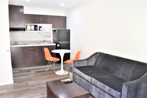 a living room with a couch and a table and a kitchen at Howard Johnson Suites by Wyndham San Diego Chula Vista BayFront in Chula Vista
