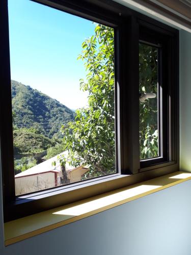 a window with a view of a mountain at Dong Bi Villa in Gukeng