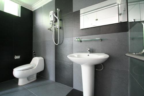 a bathroom with a sink and a toilet at T Hotel Johor Bahru in Skudai