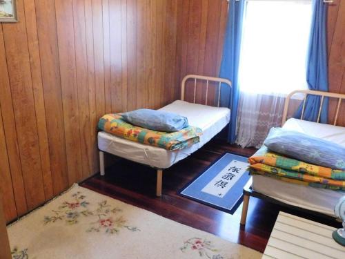 a room with two twin beds and a window at Cottage 57 - Topspot Cottages in Jurien Bay