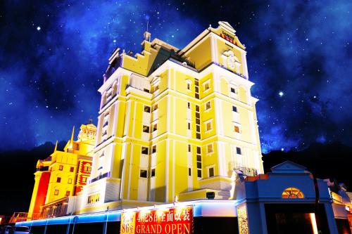 a large yellow building with a clock tower at i RESORT ARTIA Sensual Gifu (Adult Only) in Ginan