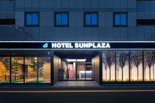 a building with a hotel superpakasia sign on it at Hotel Sunplaza in Osaka