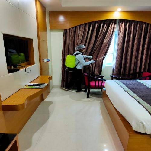 a person with a backpack standing in a hotel room at HOTEL ANAND INTERNATIONAL in Bodh Gaya
