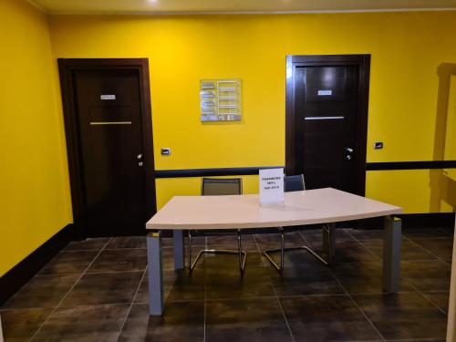 a table in a room with two doors at Vercelli Palace Hotel in Vercelli