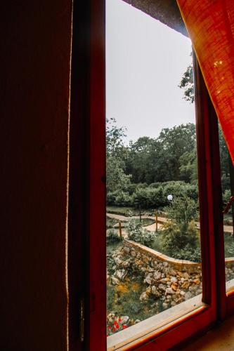 a window with a view of a garden at Villa Lilia by Let in Siena