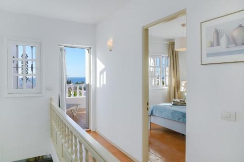 a room with a hallway with a bed and a mirror at La Lujancita in Puerto del Carmen