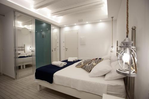 a bedroom with a large bed and a bathroom at Le Tolde del Corallone in Tropea