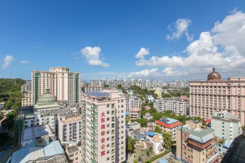 an aerial view of a city with tall buildings at Sanya Sun and Sea Gueshouse in Sanya