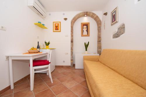 a living room with a couch and a table at Studio May in Piran
