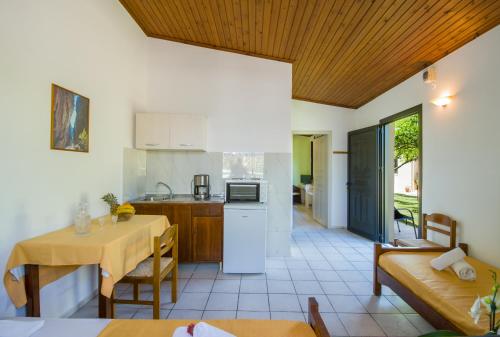 a kitchen and a living room with a table and a table at Studios Kydonia in Gerani Chanion