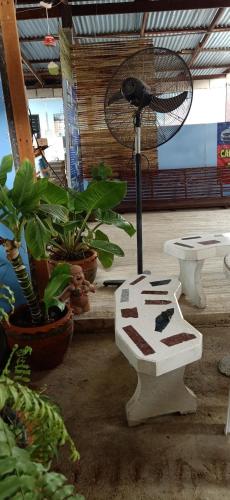 a room with plants and a table and a fan at Canaan in Kanchanaburi