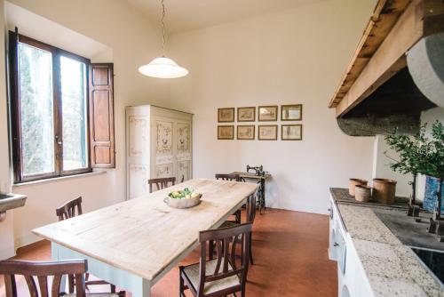a dining room with a large wooden table and chairs at Tenuta Santa Trice in Riotorto