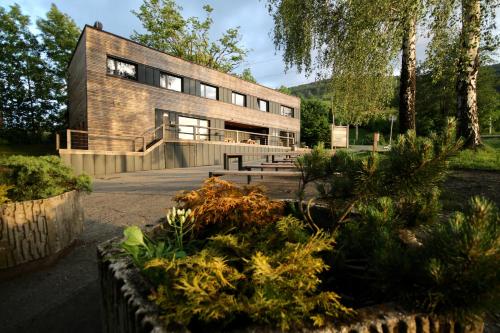 a house in a garden with plants in front of it at Flight Park Javorovy in Třinec