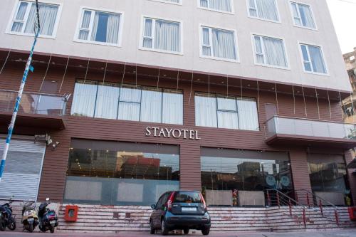 a car parked in front of a building at Stayotel Kolkata Airport in Kolkata