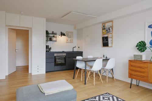 a living room and kitchen with a table and chairs at Welcome in - Ferienwohnung 'Tremonia', gegenüber der Piste mit Balkon in Winterberg