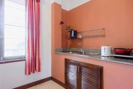 a kitchen with a sink and a window at Palm Village in Rawai Beach
