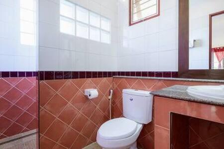 a bathroom with a toilet and a sink at Palm Village in Rawai Beach