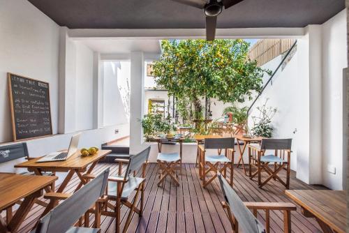 a dining room with tables and chairs and a chalkboard at Lemon Tree Stay in Faro
