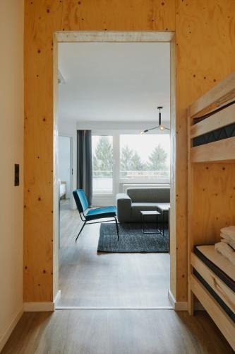 a living room with a couch and a table at Welcome in - Modernes Apartment 70-MA in der Nähe der Skipiste in Winterberg