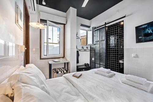 a bedroom with a large white bed and a shower at Lemon Tree Stay in Faro
