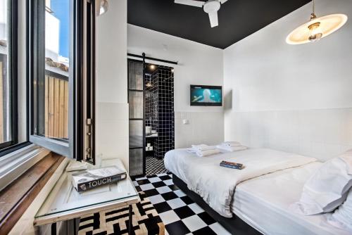 a bedroom with a bed and a checkerboard floor at Lemon Tree Stay in Faro