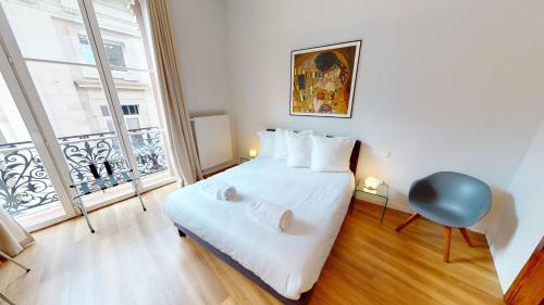 um quarto com uma cama e uma grande janela em Bleu Mésange - 2 Bedrooms and 2 Bathrooms em Estrasburgo