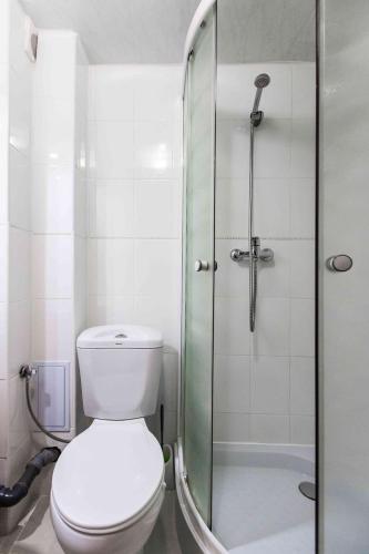 a bathroom with a toilet and a glass shower at Shepilska Relax Complex in Dovholuka