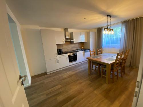 a kitchen and dining room with a table and chairs at holiday-apartments in Bremen