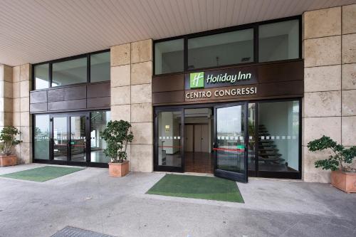 a building with the entrance to a cincinnati cultural conference at Holiday Inn Naples by IHG in Naples