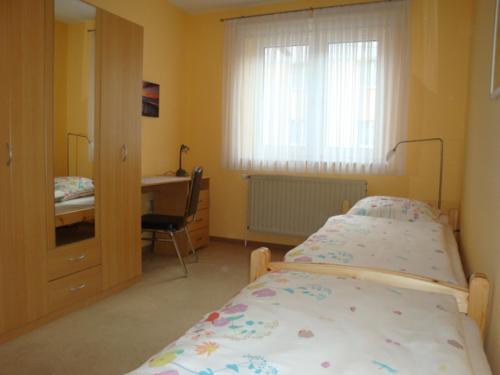 a hospital room with a bed and a desk at Ferienwohnung S und K Bremerhaven in Bremerhaven