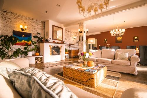 a living room with a couch and a fireplace at Akasha Retreat in Bran