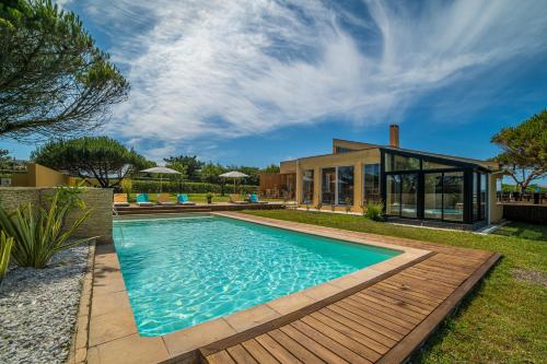 a swimming pool in the backyard of a house at Sense of Ofir in Fão
