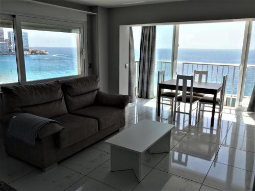a living room with a couch and a table at Apartamentos Altea Darsena - Family Apartments in Benidorm