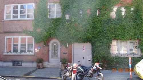 a motorcycle is parked in front of a brick building at B&B Eleven in Bruges
