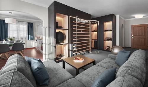 a living room with a couch and a table at Lisi Family Hotel in Reith bei Kitzbühel