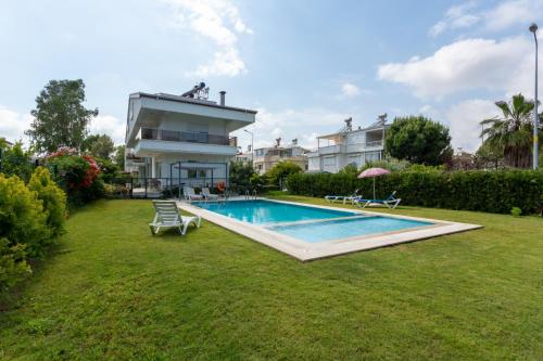 a house with a swimming pool in a yard at EV Apartments in Belek
