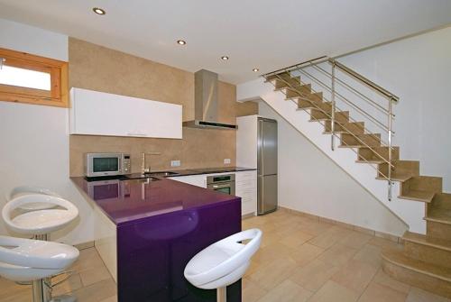 a kitchen with two toilets and a purple counter at Vinagrella in Llubí