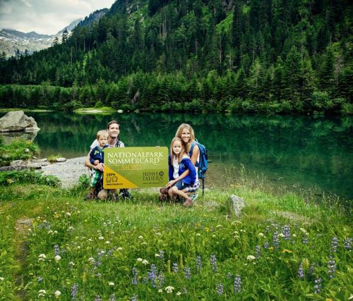 a group of people holding a sign next to a lake at Appartement Ronacher in Mittersill