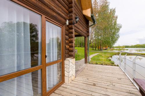 an open door to a house with a view of the water at Shepilska Relax Complex in Dovholuka