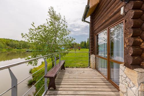 a wooden walkway next to a building with a bench at Shepilska Relax Complex in Dovholuka