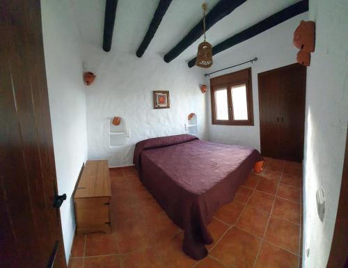 Casas Rurales La Minilla tesisinde bir odada yatak veya yataklar
