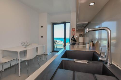 a kitchen with a sink and a table at Apartamento Astrolab in Funchal