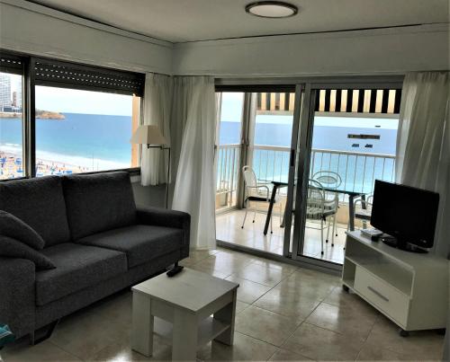 a living room with a couch and a television at Apartamentos Altea Darsena - Family Apartments in Benidorm